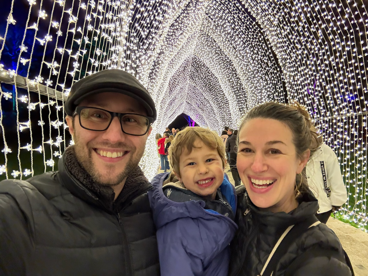 The family in a light tunnel in the botanical gardens